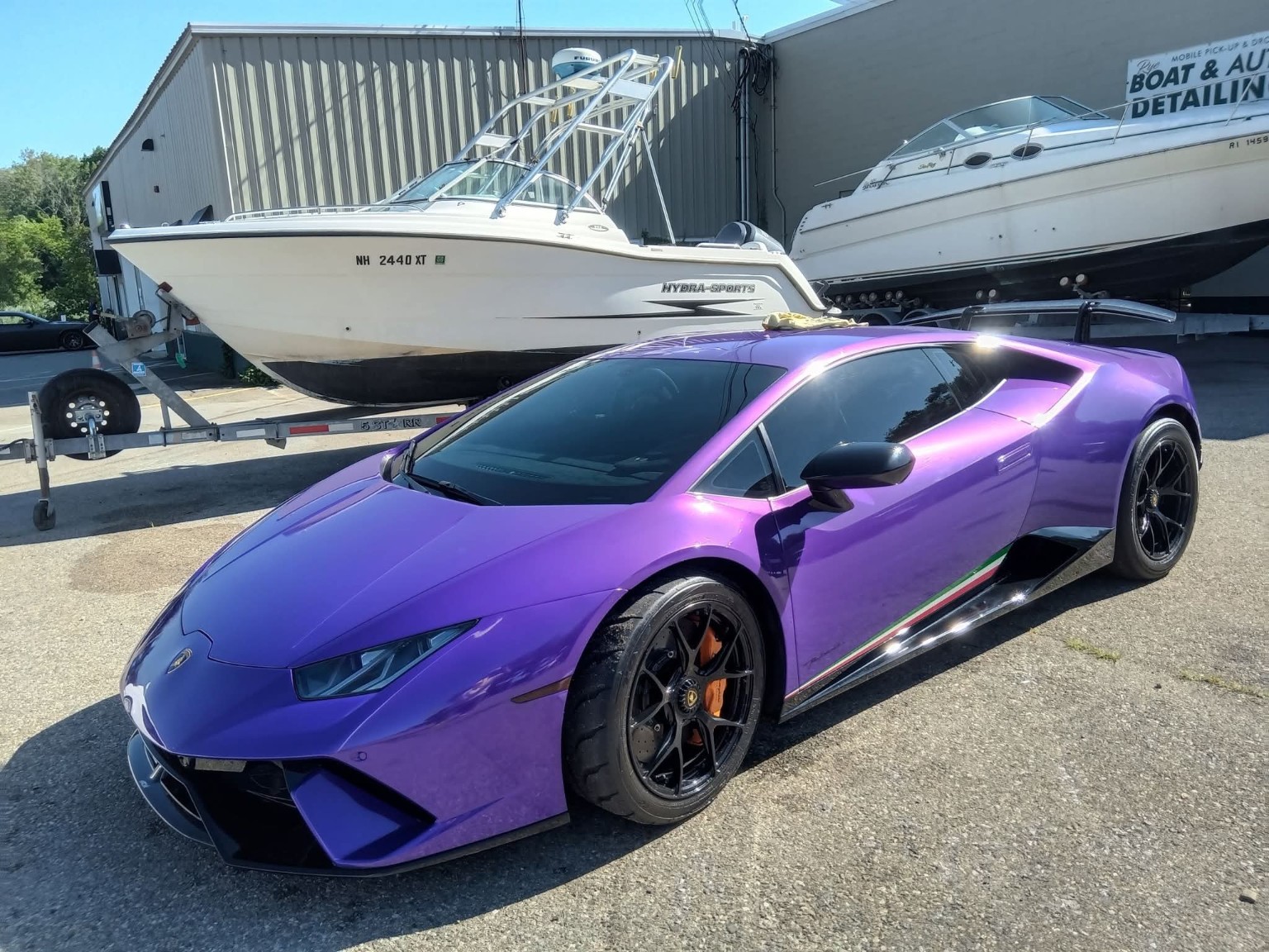 Purple Lamborghini alongside boats after premium detailing
